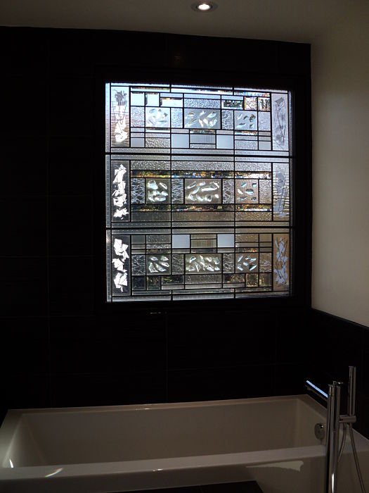Contemporary stained glass window beside bathtub